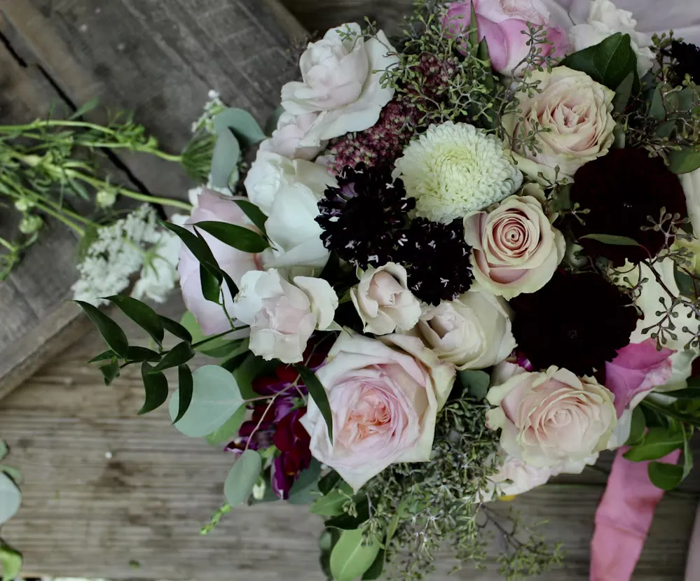 A generous bouquet of blush and ivory flowers