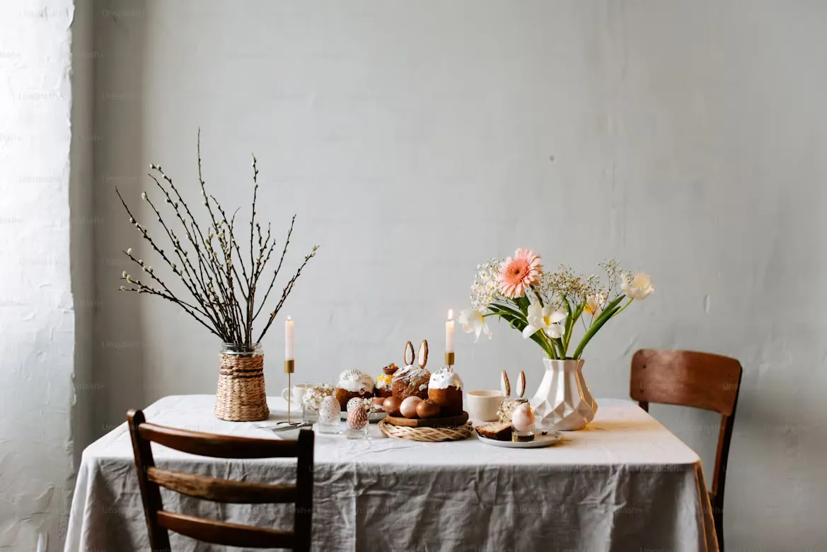 A dining table with a floral centrepiece and candles