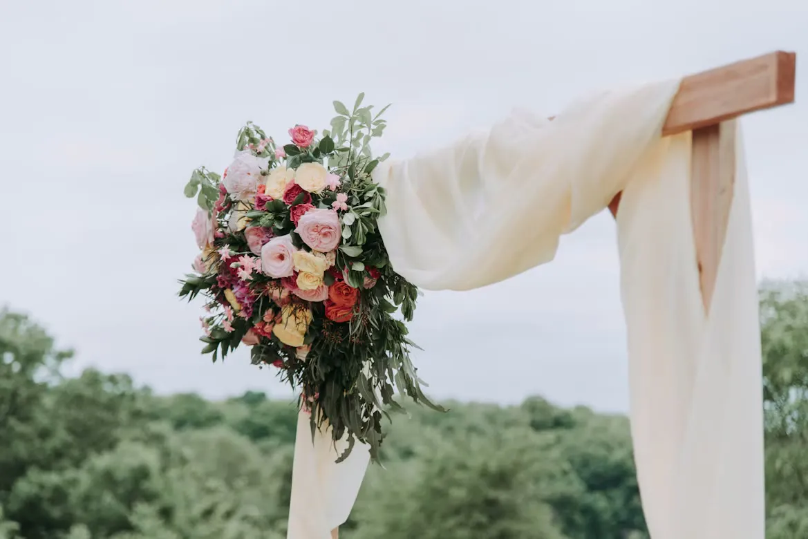 A floral arch and bridal bouquet
